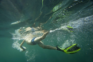A diver in flippers snorkeling.