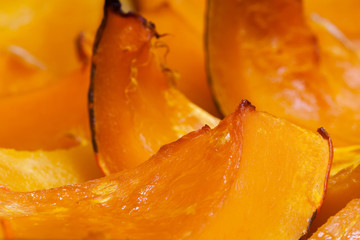 Vivid orange colour slices of baked pumpkin with honey, hot dessert in autumn