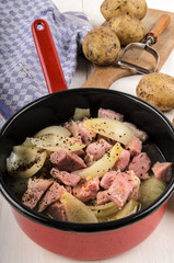 scottish specialty stovies in a pot and dirty potatoes in the ba