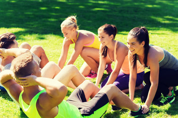 group of friends or sportsmen exercising outdoors