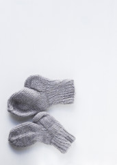A piece of grey knitting on a white background