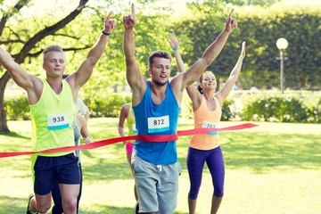 happy young male runner winning on race finish