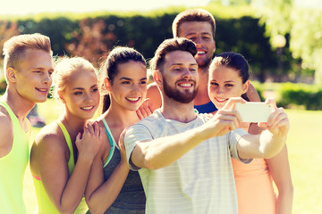 happy friends taking selfie with smartphone