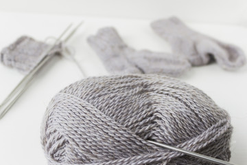 Fototapeta na wymiar A piece of grey knitting on a white background