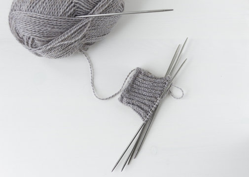 A piece of grey knitting on a white background