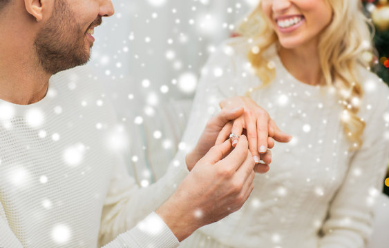 man giving diamond ring to woman for christmas