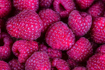 raspberries in a bowl on a wooden background