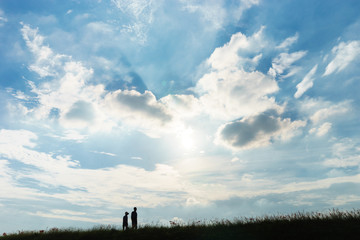 Obraz na płótnie Canvas Mature couple walking under the beautiful sky