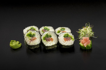 fresh sushi rolls hosomaki decorated with seaweed salad and wasa