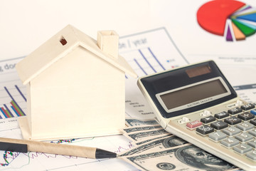 Fototapeta na wymiar Miniature house with money and chart