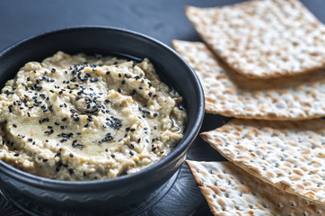 Bowl of baba ghanoush with matzo