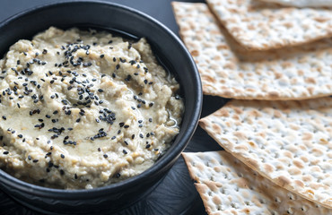 Bowl of baba ghanoush with matzo