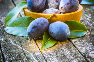 fresh plums on wooden table