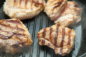 beef steak cooking over flaming grill