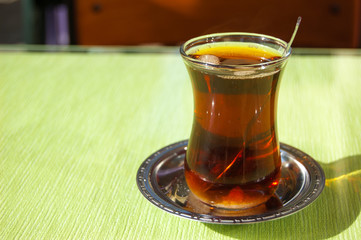 Glass of Turkish tea in traditional shapes