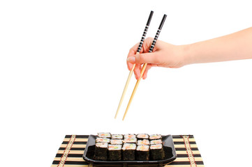 Hand takes sushi isolated. Asian food