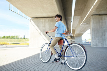 Fototapeta premium young hipster man riding fixed gear bike