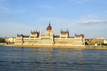 Fototapeta premium Famous building of Hungarian Parliament along the Danube River in Budapest. The Parliament, built in Neo-Gothic style and located on the bank of Danube.