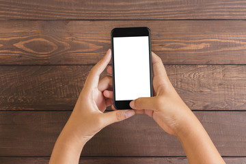 phone in woman hand showing white screen on wood table
