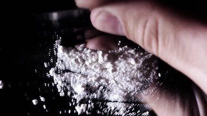 Cutting up rock cocaine. - Powered by Adobe