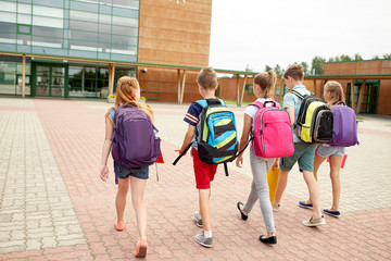 group of happy elementary school students walking