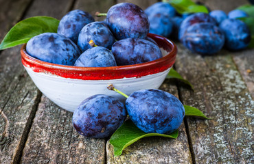 fresh plums on wooden table