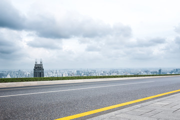 cityscape and skyline of shanghai from empty asphalt road