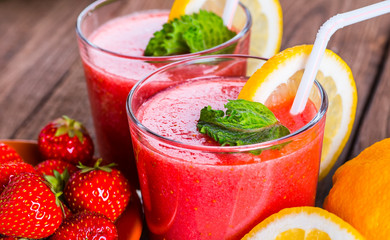 Strawberry on wood background. Strawberry with green leaves.