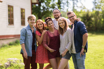 happy teenage friends hugging at summer garden