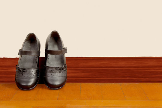 School Girl Black Pair of Shoes on Wooden Floor