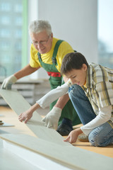 man and grandson repairing in the room