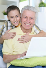 boy and grandfather with  laptop