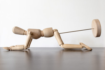 fun wooden figurine of a man at a reception at the proctologist to inspect the anus or anal sex