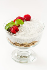 Chia yogurt with raspberries in a glass cup isolated

