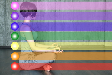 Woman practicing meditation with the chakras. Beautiful young woman doing yoga meditation in lotus posture with the activation of the chakras on the body
