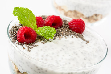 Chia yogurt with raspberries in a glass cup isolated

