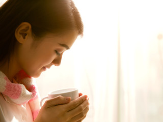 Asian women are drinking coffee in the morning she felt very ref