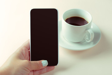 smartphone and coffee on the table