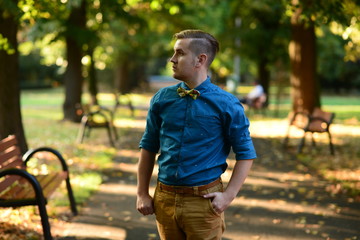 Portret of confident man in a park in fall