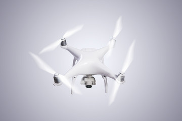 Naklejka na ściany i meble Flying helicopter drone with camera. Studio shot.