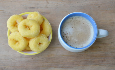 mini donuts on cup and milk coffee