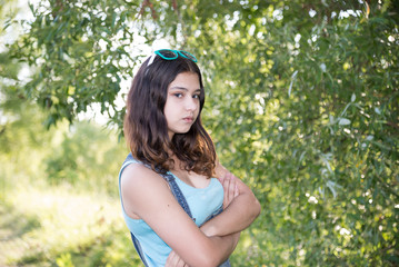 Teen girl standing near tree