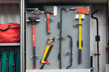 A set of tools and equipment in a fire truck at the bottom of a
