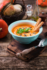 Roasted pumpkin and carrot soup with cream and pumpkin seeds