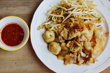 large noodle with pork ball dressing black sweet soy sauce and cayenne pepper
