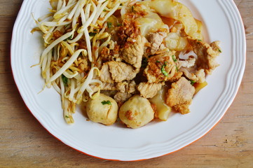 large noodle with pork ball dressing black sweet soy sauce on plate