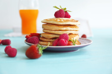 Tasty pancakes with berries on plate