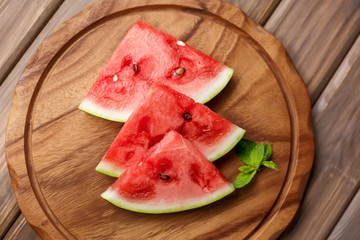 Watermelon slices on the wooden background