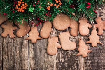 Christmas wooden background with fir tree,Gingerbread Cookies and holiday decor