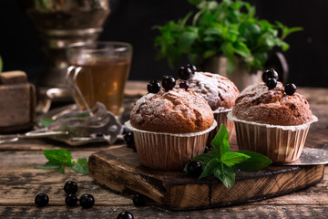 Blueberry muffins with powdered sugar and fresh berries